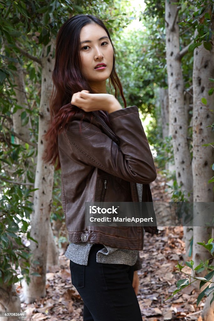 Cover-girl Portrait of a beautiful young Asian model in the park during a chilly day. 18-19 Years Stock Photo