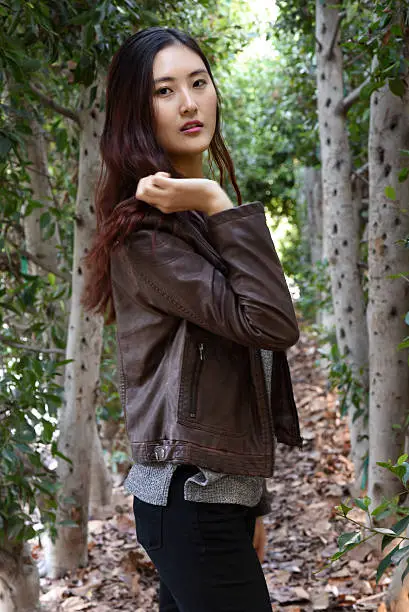 Portrait of a beautiful young Asian model in the park during a chilly day.