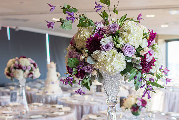High floral centerpiece with pink roses, white hydrangeas, and red anemones.