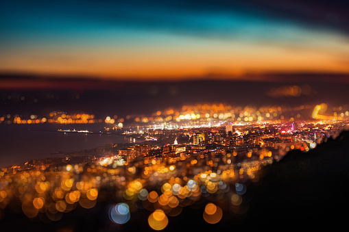 Tilt shift blur effect. Night aerial view panorama of Varna Town, Bulgaria