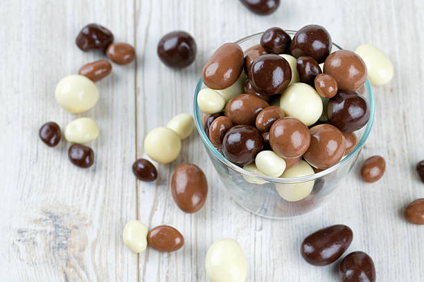 istock chocolate covered nuts and raisins on wooden surface 637084208