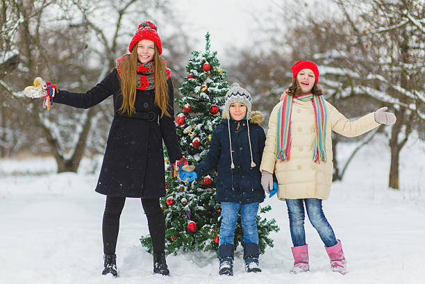 istock happy children decorating New Year tree with toy balls in 637085532