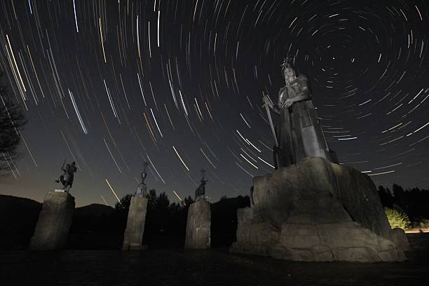 istock Statues of medieval knights under a starry sky 637087540