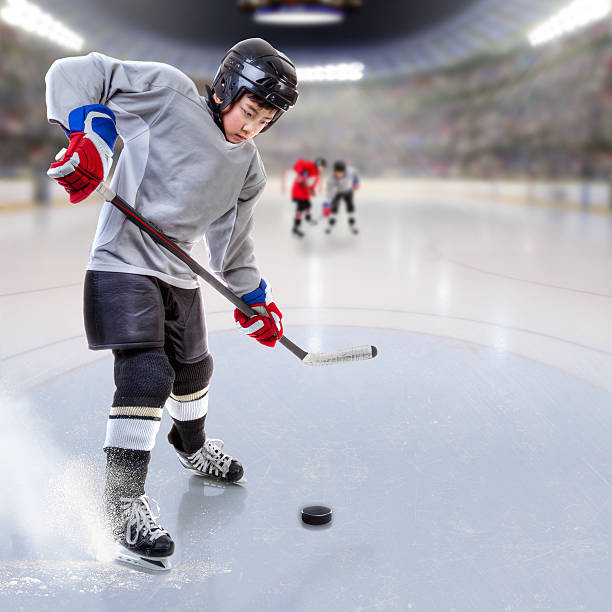 istock Junior Hockey Player Puck Handling in Arena 637088544