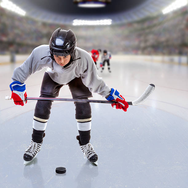 istock Junior Ice Hockey Player in Crowded Arena 637088554