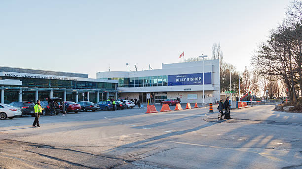 People at outside of Billy Bishop Airport building in Toronto Toronto, Canada - January 1, 2017: People at outside of Billy Bishop Airport building in Toronto. airport porter stock pictures, royalty-free photos & images
