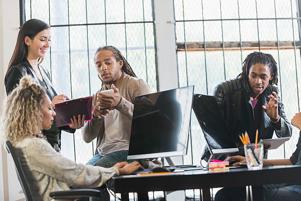 istock Multi-ethnic group of young creatives brainstorming 637090074