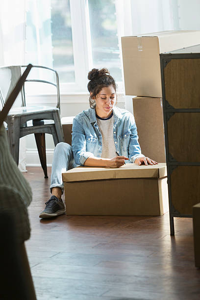istock Young mixed race woman moving, writing checklist 637090264