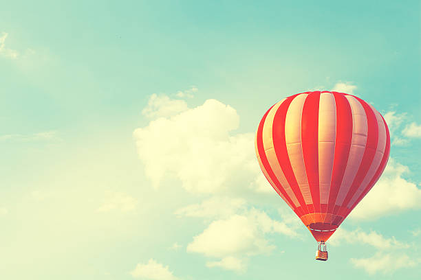 Hot air balloon on sun sky with cloud, vintage and retro instagram filter effect style
