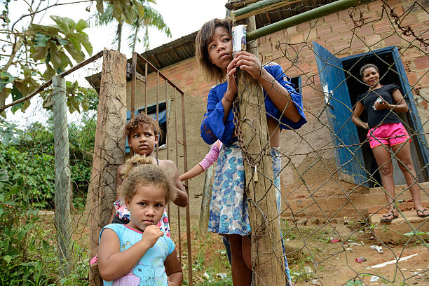 family of african kids in the village eating