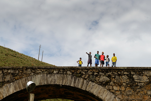Conservatória (Rio de Janeiro), Brazil - December 20, 2015: Boys on a stone bridge during a charity action of the Spiritist Center CCCV located in Valença (RJ) to deliver Christmas gifts to low income residents in Pedro Carlos rural locality.