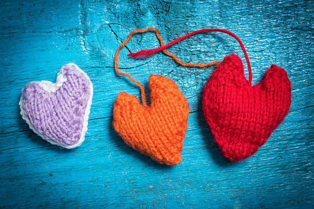 istock Colorful knitted hearts on the blue boards 637097516