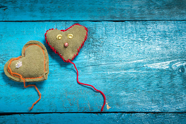 istock Colorful knitted hearts on the blue boards 637099088