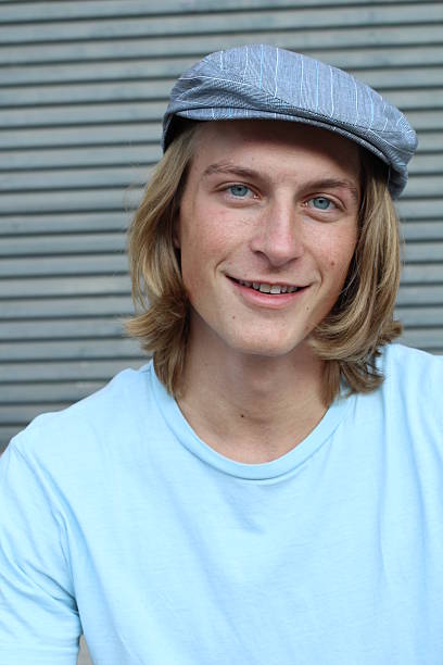 istock Caucasian man in newsboy hat smiling 637100148