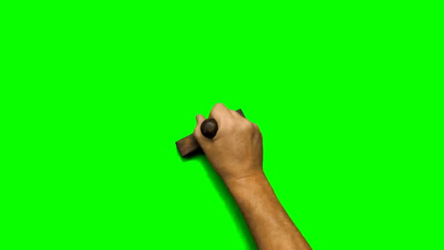 Man's hand stamping on green screen