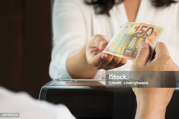 Young Man Paying Cash At Retail Shop Stock Photo - Download Image Now - Paying, Currency, Checkout