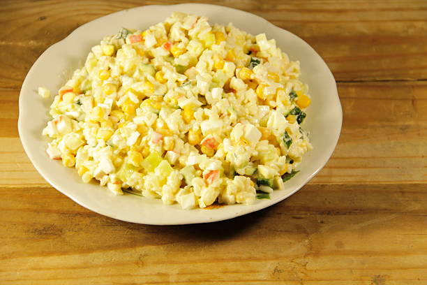 istock Salad with crab sticks, sweet corn, cucumber, eggs and rice 637105944