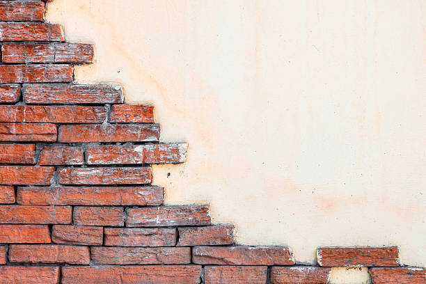 istock Red, plastered walls with cracks brick and irregularities 637106756