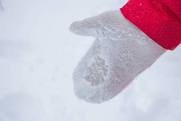 istock Ivory woman glove in snow with red coat 637107930