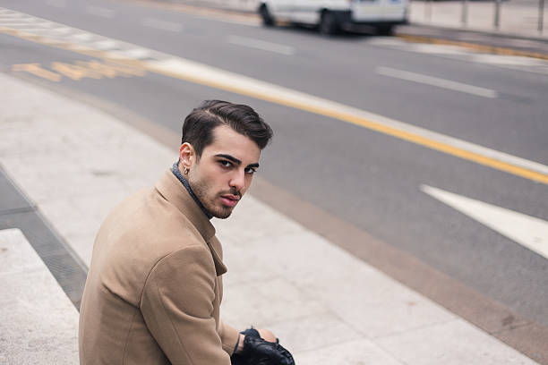 istock Beautiful young man posing in an urban context 637108310