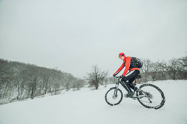 istock Extreme cyclist rides in the winter snowy forest 637109676