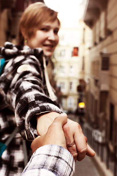 istock Follow me Concept Woman pulling Man Hand toward street 637109778