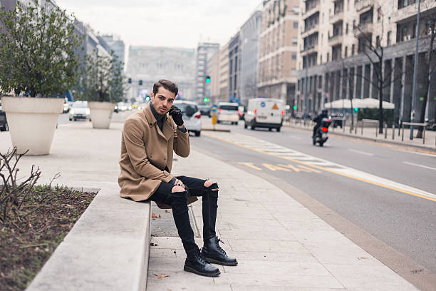 Beautiful young man with short hair posing in an urban context