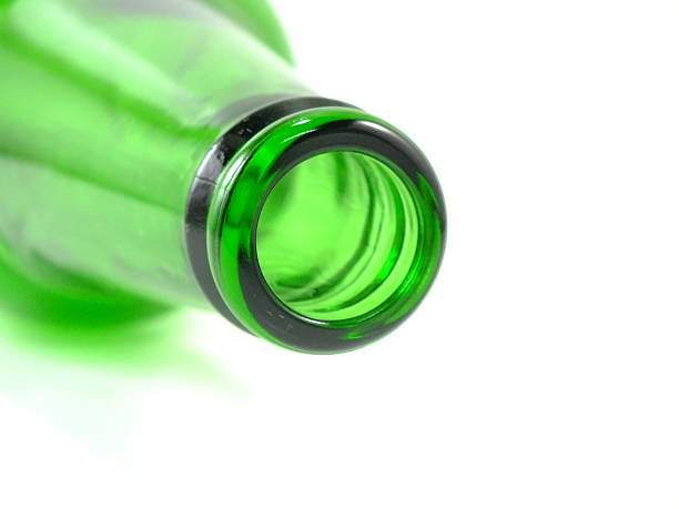 istock empty green glass bottle lying on isolated over white background 637111360