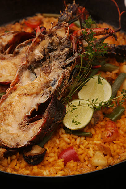paella di pesce - seafood lobster paella prepared shellfish foto e immagini stock