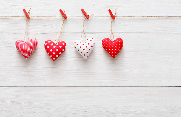 istock Valentine day background, pillow hearts border on wood, copy space 637113852