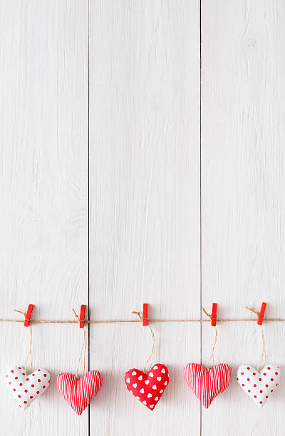istock Valentine day background, pillow hearts border on wood, copy space 637114184