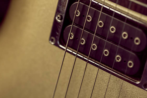 istock Soft image of a humbucker pickup on a gold guitar 637115324