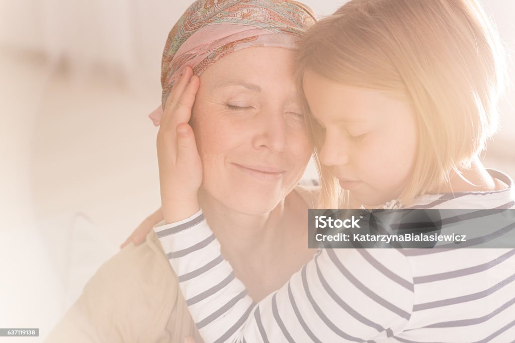 Small caring child embracing mother Small caring child embracing mother suffering from leukemia Cancer - Illness Stock Photo