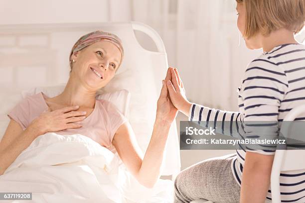 Cancer Woman Touching Childs Hand Stock Photo - Download Image Now - Leukemia, Cancer - Illness, Women