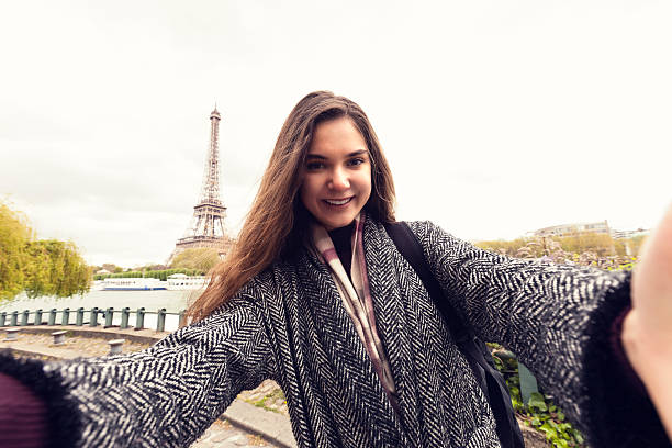 istock Smiling young women making selfie in front Eiffel tower 637119734