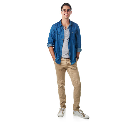 Studio portrait of a handsome young man standing with his hands in his pockets isolated on white