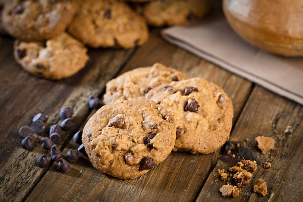 Homemade chocolate chip cookies on rustic wood table. DSRL studio photo taken with Canon EOS 5D Mk II and EF 100mm f/2.8L Macro IS USM