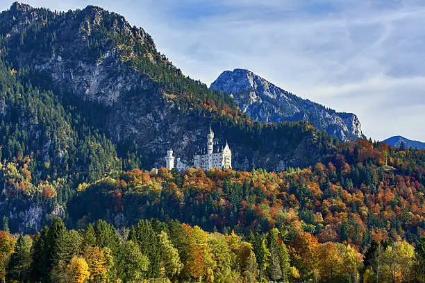 Splendid sunset scene on Neuschwanstein Castle with colorful sky and autumn trees. Bavaria, Germany.