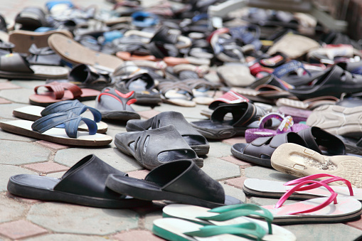 A number of shoes left outside the temple in Thailand
