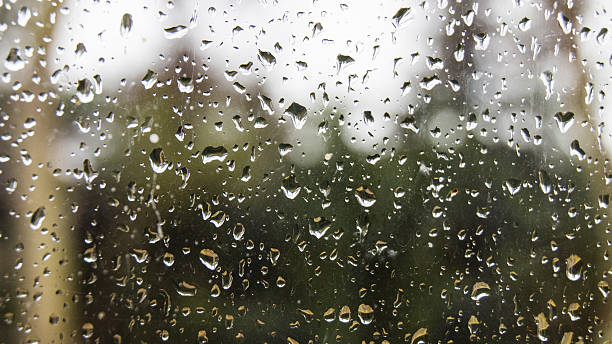 istock Drops of rain on the window glass with blurred background 637129972