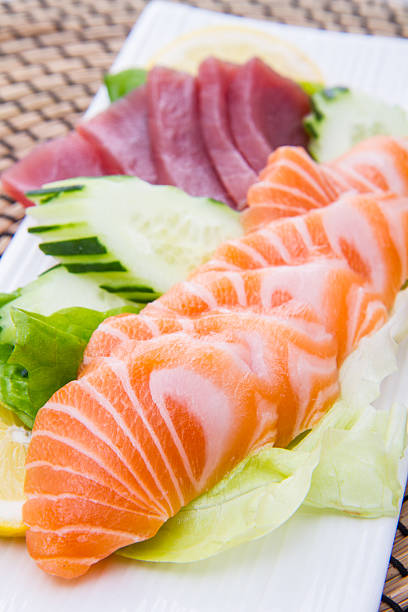 istock tuna and salmon sashimi on black dish 637130426