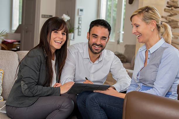 istock young couple signing contract with agent 637130948