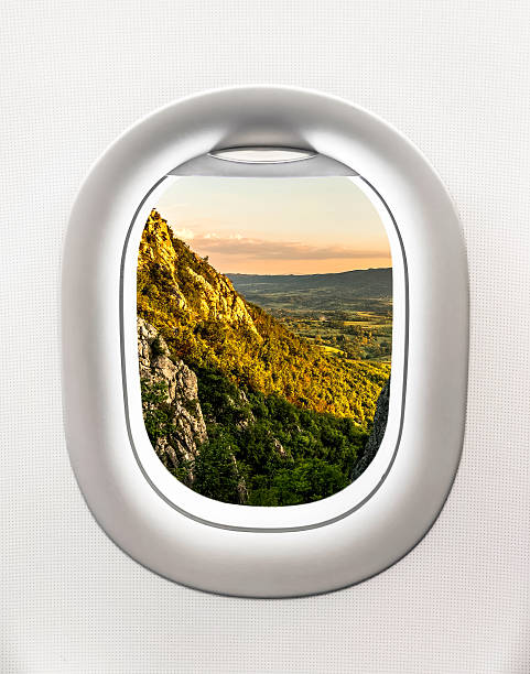 istock View of mountains and sunset from airplane window 637132140