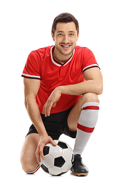 istock Football player posing with a soccer ball 637132526