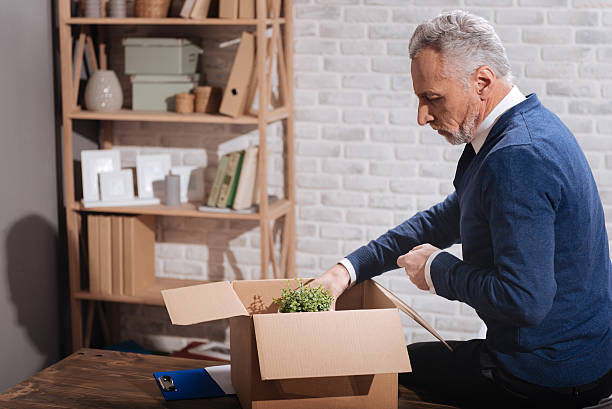 istock Depressed senior man gathering his belongings 637134920