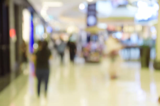 istock blurred image abstract people walking in shopping centre. 637135170