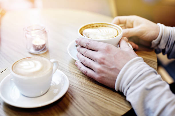 istock Two coffee cups on table in modern cafe. St. Valentines 637135458