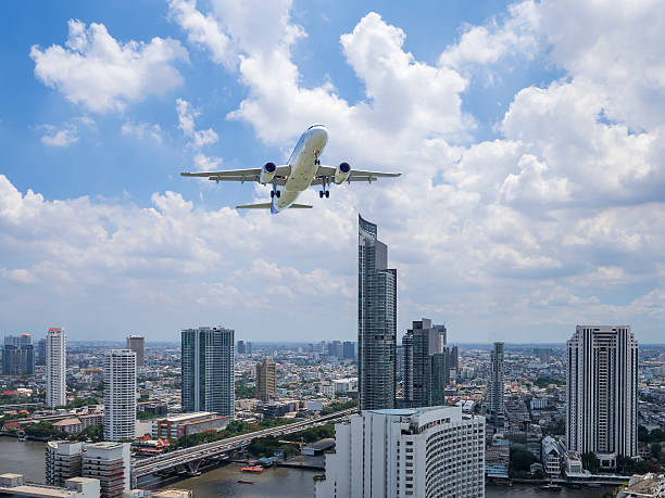 istock Airplane flying over modern building 1 637136256