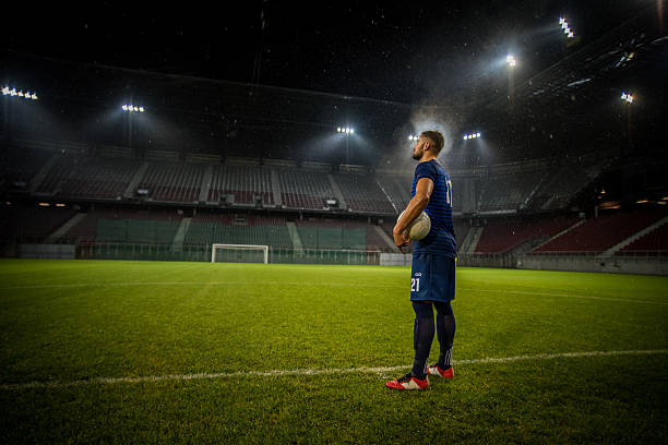 istock Football player standing in stadium 637137488