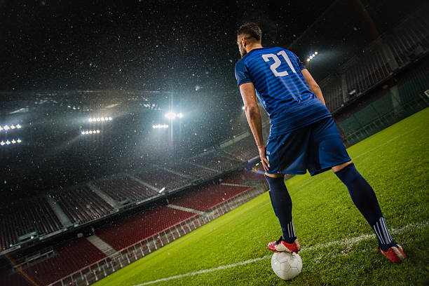 istock Football player standing in stadium 637137542
